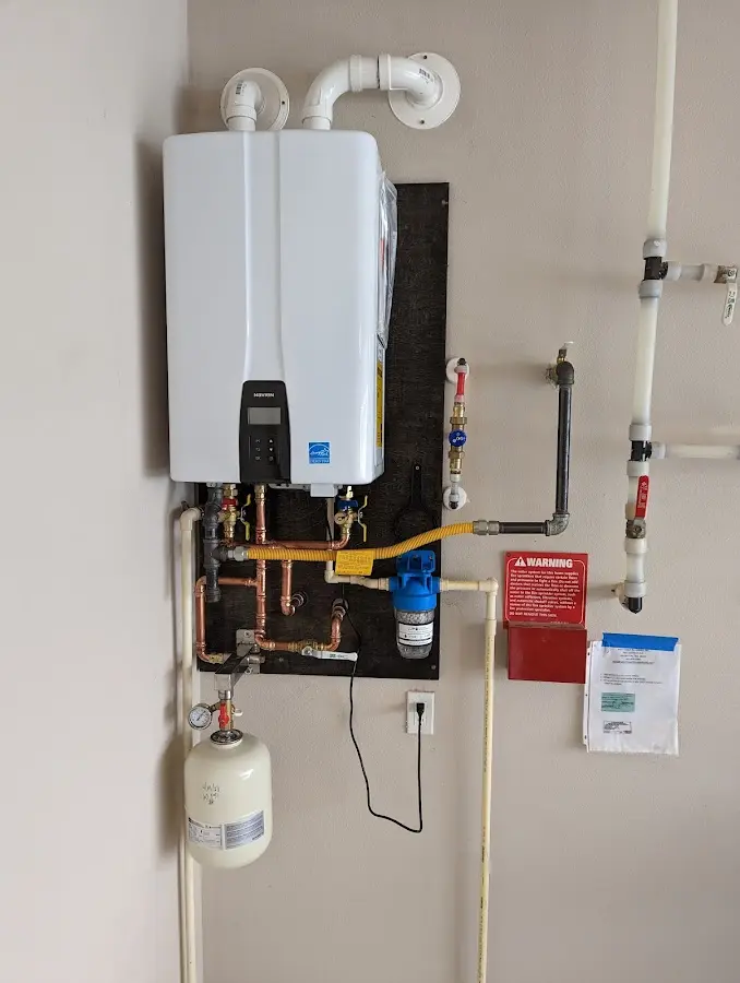 Professional plumber installing copper piping in a Duvall home